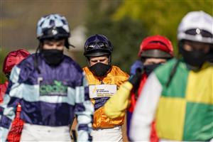 SUNBURY, ENGLAND - FEBRUARY 27: Harry Skelton makes his way to the parade ring with the other jockeys for the first race of the day at Kempton Park Racecourse on February 27, 2021 in Sunbury, England. Due to the coronavirus pandemic, owners along with the paying public will not be allowed to attend the meeting. (Photo by Alan Crowhurst/Getty Images)