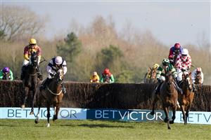 NEWBURY, ENGLAND - MARCH 06: David Noonan riding Umbrigado (L, yellow cap) clear the last to win The BetVictor Greatwood Gold Cup Handicap Chase at Newbury Racecourse on March 06, 2021 in Newbury, England. Due to the coronavirus pandemic, owners along with the paying public will not be allowed to attend the meeting. (Photo by Alan Crowhurst/Getty Images)