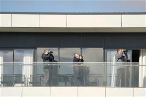 NEWBURY, ENGLAND - MARCH 06: A general view as residents watch the race action from the top apartment situated just to the side of the track at Newbury Racecourse on March 06, 2021 in Newbury, England. Due to the coronavirus pandemic, owners along with the paying public will not be allowed to attend the meeting. (Photo by Alan Crowhurst/Getty Images)