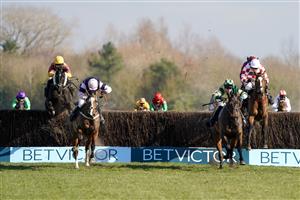 NEWBURY, ENGLAND - MARCH 06: David Noonan riding Umbrigado (L, yellow cap) clear the last to win The BetVictor Greatwood Gold Cup Handicap Chase at Newbury Racecourse on March 06, 2021 in Newbury, England. Due to the coronavirus pandemic, owners along with the paying public will not be allowed to attend the meeting. (Photo by Alan Crowhurst/Getty Images)