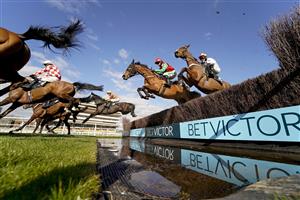 NEWBURY, ENGLAND - MARCH 06: David Noonan riding Umbrigado (farside, yellow cap) clear the water jump before going on to win The BetVictor Greatwood Gold Cup Handicap Chase at Newbury Racecourse on March 06, 2021 in Newbury, England. Due to the coronavirus pandemic, owners along with the paying public will not be allowed to attend the meeting. (Photo by Alan Crowhurst/Getty Images)