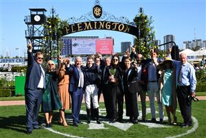 MELBOURNE, AUSTRALIA - MARCH 06: Matthew Gudinski , son of famed entrepreneur Michael Gudinski poses with Jye McNeil and other connections after Homesman won Race 8, the Tab Australian Cup, during Melbourne Racing at Flemington Racecourse on March 06, 2021 in Melbourne. Michael Gudinski died peacefully in his sleep at his home in Melbourne this week aged 68. (Photo by Vince Caligiuri/Getty Images)