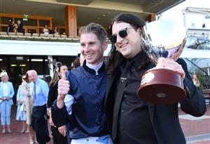MELBOURNE, AUSTRALIA - MARCH 06: Matthew Gudinski , son of famed entrepreneur Michael Gudinski poses with Jye McNeil after Homesman won Race 8, the Tab Australian Cup, during Melbourne Racing at Flemington Racecourse on March 06, 2021 in Melbourne. Michael Gudinski died peacefully in his sleep at his home in Melbourne this week aged 68. (Photo by Vince Caligiuri/Getty Images)