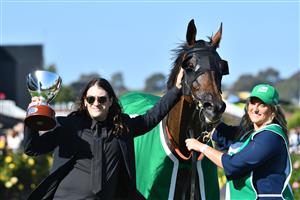 MELBOURNE, AUSTRALIA - MARCH 06: Matthew Gudinski , son of famed entrepreneur Michael Gudinski poses with Homesman after winning Race 8, the Tab Australian Cup, during Melbourne Racing at Flemington Racecourse on March 06, 2021 in Melbourne. Michael Gudinski died peacefully in his sleep at his home in Melbourne this week aged 68. (Photo by Vince Caligiuri/Getty Images)