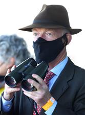 CHELTENHAM, ENGLAND - MARCH 16: Trainer Willie Mullins watches on during the Close Brothers Mares' Hurdle (Grade 1) on Day One of the Cheltenham Festival at Cheltenham Racecourse on March 16, 2021 in Cheltenham, England. Sporting venues around the UK remain under strict restrictions due to the Coronavirus Pandemic as Government social distancing laws prohibit spectators inside venues resulting in events being held behind closed doors. (Photo by Michael Steele/Getty Images)