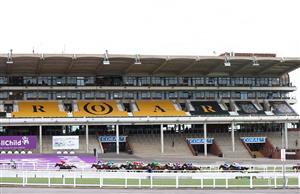CHELTENHAM, ENGLAND - MARCH 17: The field rides past the grand stand during the Coral Cup Handicap Hurdle (Grade 3) race on Day Two of the Cheltenham Festival 2021 at Cheltenham Racecourse on March 17, 2021 in Cheltenham, England. Sporting venues around the UK remain under strict restrictions due to the Coronavirus Pandemic as Government social distancing laws prohibit spectators inside venues resulting in events being held behind closed doors. (Photo by Michael Steele/Getty Images)