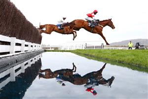 CHELTENHAM, ENGLAND - MARCH 17: Monkfish (L) ridden by Paul Townend and The Big Breakaway (R) ridden by Harry Cobden jump a water fence during the Brown Advisory Novices' Chase (Grade 1) on Day Two of the Cheltenham Festival 2021 at Cheltenham Racecourse on March 17, 2021 in Cheltenham, England. Sporting venues around the UK remain under strict restrictions due to the Coronavirus Pandemic as Government social distancing laws prohibit spectators inside venues resulting in events being held behind closed doors. (Photo by Michael Steele/Getty Images)