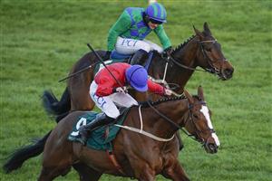 CHELTENHAM, ENGLAND - MARCH 17: Rachael Blackmore riding Sir Gerhard (red) win The Weatherbys Champion Bumper from Paul Townend and Kilcruit (green) at Cheltenham Racecourse on March 17, 2021 in Cheltenham, England. Sporting venues around the UK remain under strict restrictions due to the Coronavirus Pandemic as Government social distancing laws prohibit spectators inside venues resulting in events being held behind closed doors. (Photo by Alan Crowhurst/Getty Images)