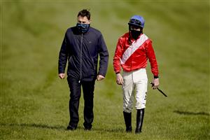 CHELTENHAM, ENGLAND - MARCH 18: Jockey Jack Kennedy is met by trainer Henry de Bromhead after falling from Envoi Allen during The Marsh Novices' Chase at Cheltenham Racecourse on March 18, 2021 in Cheltenham, England. Sporting venues around the UK remain under strict restrictions due to the Coronavirus Pandemic as Government social distancing laws prohibit spectators inside venues resulting in events being held behind closed doors. (Photo by Alan Crowhurst/Getty Images)