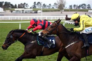 CHELTENHAM, ENGLAND - MARCH 19: Porlock Bay (left) ridden by Lorcan Williams on their way to winning the St. James's Place Festival Challenge Cup Open Hunters' Chase on day four of the Cheltenham Festival at Cheltenham Racecourse, on March 19, 2021 in Cheltenham, England. Sporting venues around the UK remain under strict restrictions due to the Coronavirus Pandemic as Government social distancing laws prohibit spectators inside venues resulting in events being held behind closed doors. (Photo by Tim Goode - Pool/Getty Images)