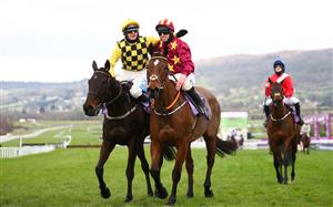 CHELTENHAM, ENGLAND - MARCH 19: Paul Townend (L) ridding Al Boum Photo congratulates Jack Kennedy ridding Jockey of Minella Indo after the WellChild Cheltenham Gold Cup Chase (Grade 1) race on Day Four of the Cheltenham Festival 2021 at Cheltenham Racecourse on March 19, 2021 in Cheltenham, England. Sporting venues around the UK remain under strict restrictions due to the Coronavirus Pandemic as Government social distancing laws prohibit spectators inside venues resulting in events being held behind closed doors. (Photo by Michael Steele/Getty Images)