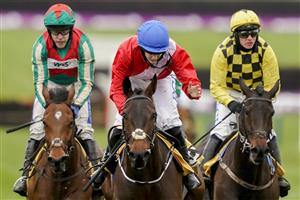 CHELTENHAM, ENGLAND - MARCH 19: Rachael Blackmore riding Quilixios (red) win The JCB Triumph Hurdle making it her sixth winner of the festival at Cheltenham Racecourse on March 19, 2021 in Cheltenham, England. Sporting venues around the UK remain under strict restrictions due to the Coronavirus Pandemic as Government social distancing laws prohibit spectators inside venues resulting in events being held behind closed doors. (Photo by Alan Crowhurst/Getty Images)
