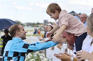 SYDNEY, AUSTRALIA - MARCH 27: Tommy Berry hugs his kids after winning the Rosehill Guineas during Golden Slipper Day at Rosehill Gardens on March 27, 2021 in Sydney, Australia. (Getty)