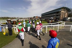 WARWICK, ENGLAND - MARCH 30: A general view as jockeys enter the parade ring for the first race at Warwick Racecourse on March 30, 2021 in Warwick, England. Sporting venues around the UK remain under restrictions due to the Coronavirus Pandemic. Only owners are allowed to attend the meeting but the public must wait until further restrictions are lifted. (Photo by Alan Crowhurst/Getty Images)