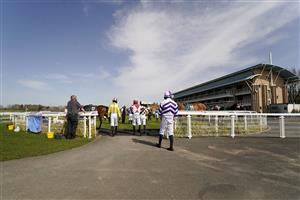 WARWICK, ENGLAND - MARCH 30: A general view as jockeys enter the parade ring for the first race at Warwick Racecourse on March 30, 2021 in Warwick, England. Sporting venues around the UK remain under restrictions due to the Coronavirus Pandemic. Only owners are allowed to attend the meeting but the public must wait until further restrictions are lifted. (Photo by Alan Crowhurst/Getty Images)