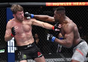 LAS VEGAS, NEVADA - MARCH 27: In this handout image provided by UFC, (R-L) Francis Ngannou of Cameroon punches Stipe Miocic in their UFC heavyweight championship fight during the UFC 260 event at UFC APEX on March 27, 2021 in Las Vegas, Nevada. (Photo by Jeff Bottari/Zuffa LLC via Getty Images)