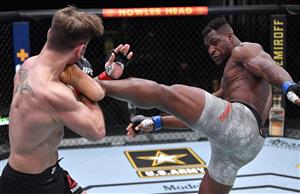 LAS VEGAS, NEVADA - MARCH 27: In this handout image provided by UFC, (R-L) Francis Ngannou of Cameroon kicks Stipe Miocic in their UFC heavyweight championship fight during the UFC 260 event at UFC APEX on March 27, 2021 in Las Vegas, Nevada. (Photo by Jeff Bottari/Zuffa LLC via Getty Images)