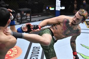 LAS VEGAS, NEVADA - MARCH 27: In this handout image provided by UFC, (R-L) Sean O'Malley kicks Thomas Almeida of Brazil in their bantamweight fight during the UFC 260 event at UFC APEX on March 27, 2021 in Las Vegas, Nevada. (Photo by Jeff Bottari/Zuffa LLC via Getty Images)
