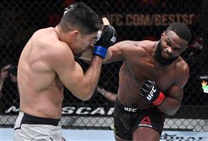 LAS VEGAS, NEVADA - MARCH 27: In this handout image provided by UFC, (R-L) Tyron Woodley punches Vicente Luque in their welterweight fight during the UFC 260 event at UFC APEX on March 27, 2021 in Las Vegas, Nevada. (Photo by Jeff Bottari/Zuffa LLC via Getty Images)