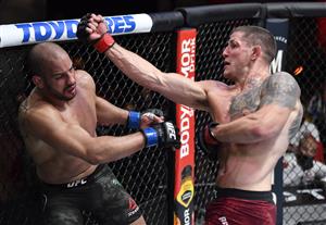 LAS VEGAS, NEVADA - MARCH 27: In this handout image provided by UFC, (R-L) Marc-Andre Barriault of Canada punches Abu Azaitar of Morocco in their middleweight fight during the UFC 260 event at UFC APEX on March 27, 2021 in Las Vegas, Nevada. (Photo by Jeff Bottari/Zuffa LLC via Getty Images)
