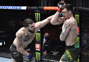LAS VEGAS, NEVADA - MARCH 27: In this handout image provided by UFC, (L-R) Michal Oleksiejczuk of Poland punches Modestas Bukauskas of Lithuania in their light heavyweight fight during the UFC 260 event at UFC APEX on March 27, 2021 in Las Vegas, Nevada. (Photo by Jeff Bottari/Zuffa LLC via Getty Images)