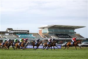 LIVERPOOL, ENGLAND - APRIL 08: Runners and riders pass in front of the empty grandstands in the Close Brothers Red Rum Handicap Chase during the Liverpool NHS Day of the 2021 Randox Health Grand National Festival at Aintree Racecourse on April 8, 2021 in Liverpool, England. (Photo by Tim Goode - Pool/Getty Images)