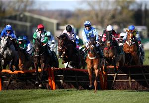 LIVERPOOL, ENGLAND - APRIL 09: A general view of runners and riders in action as they clear a fence whilst competing in the Pinsent Masons Handicap Hurdle during Ladies Day of the 2021 Randox Health Grand National Festival at Aintree Racecourse on April 9, 2021 in Liverpool, England. (Photo by Tim Goode - Pool / Getty Images)