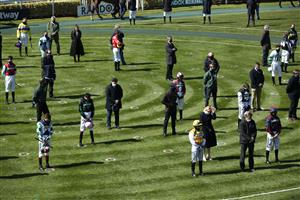 LIVERPOOL, ENGLAND - APRIL 09: Racegoers and riders observe a two-minute silence for the late Prince Philip, Duke of Edinburgh, before the Pertemps Network Handicap Hurdle during Ladies Day of the 2021 Randox Health Grand National Festival at Aintree Racecourse on April 9, 2021 in Liverpool, England. (Photo by Tim Goode - Pool / Getty Images)