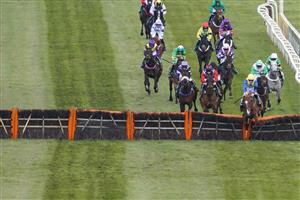 LIVERPOOL, ENGLAND - APRIL 10: Ciaran Gethings riding Hometown Boy (blue/yellow) clear the last to win The EFT Systems Handicap Hurdle at Aintree Racecourse on April 10, 2021 in Liverpool, England. Sporting venues around the UK remain under restrictions due to the Coronavirus Pandemic. Only owners are allowed to attend the meeting but the public must wait until further restrictions are lifted. (Photo by Alan Crowhurst/Getty Images) (Photo by Alan Crowhurst/Getty Images)