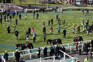 LIVERPOOL, ENGLAND - APRIL 10: Jockeys, owners and trainers stand for a two minute silence in the parade ring, following yesterdays announcement of the death of the Duke of Edinburgh at the age of 99, during Grand National Day of the 2021 Randox Health Grand National Festival at Aintree Racecourse on April 10, 2021 in Liverpool, England. (Photo by Tim Goode - Pool/Getty Images)