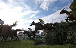 LIVERPOOL, ENGLAND - APRIL 10: Runners and riders clear the water jump during the Randox Grand National Handicap Chase, on Grand National Day of the 2021 Randox Health Grand National Festival at Aintree Racecourse on April 10, 2021 in Liverpool, England. (Photo by Tim Goode - Pool/Getty Images)