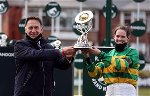 LIVERPOOL, ENGLAND - APRIL 10: Jockey Rachael Blackmore and trainer Henry De Bromhead receive the Randox Grand National Handicap Chase trophy after winning with Minella Times during Grand National Day of the 2021 Randox Health Grand National Festival at Aintree Racecourse on April 10, 2021 in Liverpool, England. (Photo by David Davies - Pool/Getty Images)