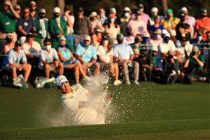 AUGUSTA, GEORGIA - APRIL 11: Hideki Matsuyama of Japan plays a shot from a bunker on the 18th hole during the final round of the Masters at Augusta National Golf Club on April 11, 2021 in Augusta, Georgia. (Photo by Mike Ehrmann/Getty Images)