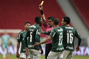BRASILIA, BRAZIL - APRIL 14: Referee Leodán González shows a yellow card to Patrick de Paula of Palmeiras during match between Palmeiras and Defensa y Justicia as part of the second leg of the Conmebol Recopa at Mane Garrincha Stadium on April 14, 2021 in Brasilia, Brazil. (Photo by Ueslei Marcelino - Pool/Getty Images)