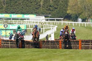 ESHER, ENGLAND - APRIL 24: David Bass riding Younevercall (orange) clear the last to win The bet365 Select Hurdle at Sandown Park Racecourse on April 24, 2021 in Esher, England. Sporting venues around the UK remain under restrictions due to the Coronavirus Pandemic. Only owners are allowed to attend the meeting but the public must wait until further restrictions are lifted. (Photo by Alan Crowhurst/Getty Images)