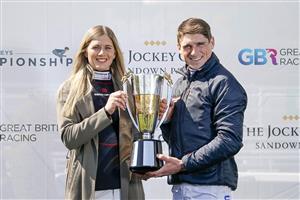 ESHER, ENGLAND - APRIL 24: Harry Skelton celebrates with his wife Bridget with the Champion Jockey trophy for the national hunt season 2020-21 at Sandown Park Racecourse on April 24, 2021 in Esher, England. Sporting venues around the UK remain under restrictions due to the Coronavirus Pandemic. Only owners are allowed to attend the meeting but the public must wait until further restrictions are lifted. (Photo by Alan Crowhurst/Getty Images)