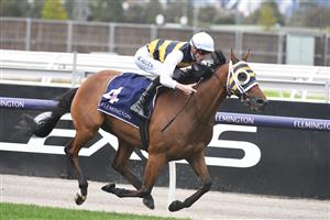 MELBOURNE, AUSTRALIA - APRIL 25: Ben Allen riding Amade winning Race 1, the William Newton Vc Handicap, during Anzac Day Race Day at Flemington Racecourse on April 25, 2021 in Melbourne, Australia. (Photo by Vince Caligiuri/Getty Images)