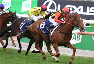 MELBOURNE, AUSTRALIA - APRIL 25: Damien Oliver riding Vassilator winning Race 7, the The Les Carlyon, during Anzac Day Race Day at Flemington Racecourse on April 25, 2021 in Melbourne, Australia. (Photo by Vince Caligiuri/Getty Images)