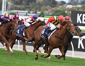 MELBOURNE, AUSTRALIA - APRIL 25: Damien Oliver riding Vassilator winning Race 7, the The Les Carlyon, during Anzac Day Race Day at Flemington Racecourse on April 25, 2021 in Melbourne, Australia. (Photo by Vince Caligiuri/Getty Images)