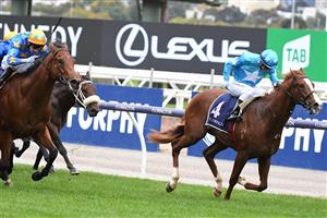 MELBOURNE, AUSTRALIA - APRIL 25: Luke Currie riding Three Kings winning Race 4, the Anzac Day Stakes, during Anzac Day Race Day at Flemington Racecourse on April 25, 2021 in Melbourne, Australia. (Photo by Vince Caligiuri/Getty Images)