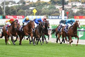 MELBOURNE, AUSTRALIA - APRIL 25: Luke Currie riding Three Kings winning Race 4, the Anzac Day Stakes, during Anzac Day Race Day at Flemington Racecourse on April 25, 2021 in Melbourne, Australia. (Photo by Vince Caligiuri/Getty Images)