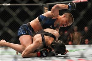 JACKSONVILLE, FL - APRIL 24: Rose Namajunas of the United States punches Zhang Weili of China during the Women's Strawweight Title bout of UFC 261 at VyStar Veterans Memorial Arena on April 24, 2021 in Jacksonville, Florida. (Getty Images)