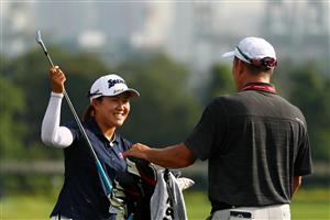 SINGAPORE, SINGAPORE - APRIL 27: Nasa Hataoka of Japan speaks with her caddie Gregory Arthur Johnston as she prepares to practice on the driving range prior to the HSBC Women's World Championship at Sentosa Golf Club on April 27, 2021 in Singapore. (Getty Images)
