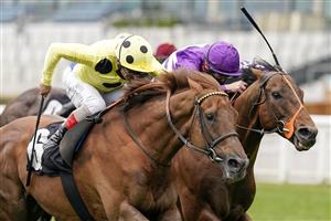 ASCOT, ENGLAND - APRIL 28: Tom Marquand riding Oh This Is Us (purple) win The Charlie Waller Trust Paradise Stakes from Andrea Atzeni riding Prince Eiji at Ascot Racecourse on April 28, 2021 in Ascot, England. Sporting venues around the UK remain under restrictions due to the Coronavirus Pandemic. Only owners are allowed to attend the meeting but the public must wait until further restrictions are lifted. (Photo by Alan Crowhurst/Getty Images)
