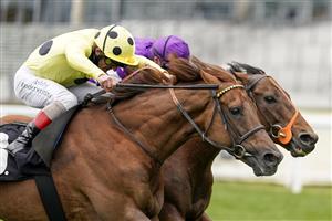 ASCOT, ENGLAND - APRIL 28: Tom Marquand riding Oh This Is Us (purple) win The Charlie Waller Trust Paradise Stakes from Andrea Atzeni riding Prince Eiji at Ascot Racecourse on April 28, 2021 in Ascot, England. Sporting venues around the UK remain under restrictions due to the Coronavirus Pandemic. Only owners are allowed to attend the meeting but the public must wait until further restrictions are lifted. (Photo by Alan Crowhurst/Getty Images)