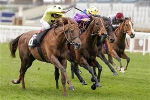 ASCOT, ENGLAND - APRIL 28: Tom Marquand riding Oh This Is Us (purple) win The Charlie Waller Trust Paradise Stakes from Andrea Atzeni riding Prince Eiji at Ascot Racecourse on April 28, 2021 in Ascot, England. Sporting venues around the UK remain under restrictions due to the Coronavirus Pandemic. Only owners are allowed to attend the meeting but the public must wait until further restrictions are lifted. (Photo by Alan Crowhurst/Getty Images)