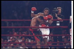7 Feb 1997: Oliver McCall stumbles as Lennox Lewis looks on during a bout at the Las Vegas Hilton in Las Vegas, Nevada. Lewis won the fight. (Getty Images)