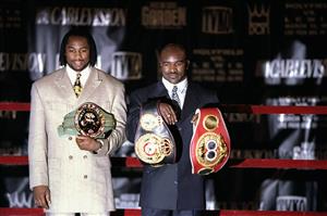 30 Nov 1998: Lennox Lewis (left) and Evander Holyfield display their title belts during the Holyfield- Lewis Press Conference at Madison Square Garden in New York, New York. (Getty Images)