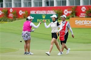 SINGAPORE, SINGAPORE - APRIL 30: Chella Choi (C) of South Korea and Jasmine Suwannapura (L) of Thailand fist bump after holing out on the 18th green during the second round of the HSBC Women's World Championship at Sentosa Golf Club on April 30, 2021 in Singapore. (Getty Images)