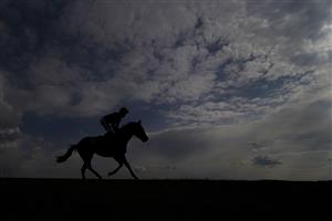 NEWMARKET, ENGLAND - MAY 02: A general view as runners ease down after finishing The at Newmarket Racecourse on May 02, 2021 in Newmarket, England. Only owners are allowed to attend the meeting but the public must wait until further restrictions are lifted. (Photo by Alan Crowhurst/Getty Images)Betfair British EBF Maiden Stakes